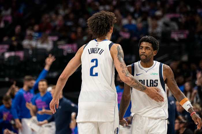 Dallas Mavericks' Dereck Lively II and Kyrie Irving celebrating after a play.